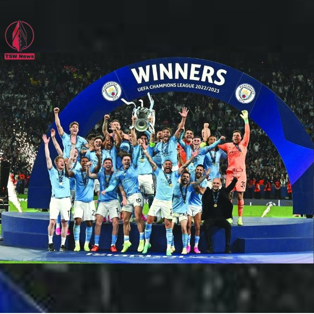 Manchester City players and coach Pep Guardiola celebrate with the trophy after winning the UEFA Champions